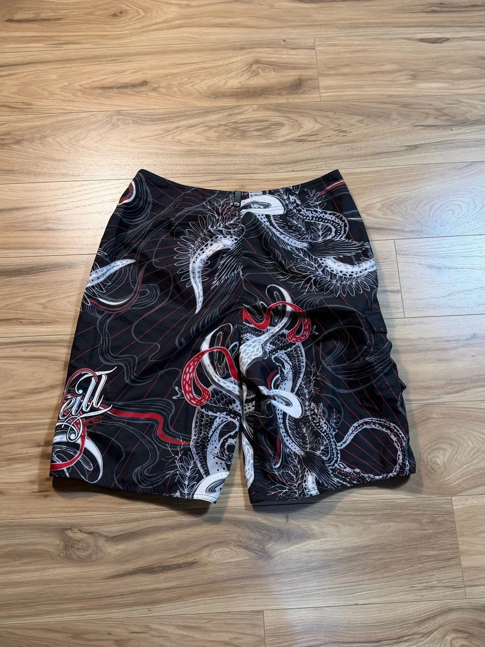 O'Neill black board shorts with white and red